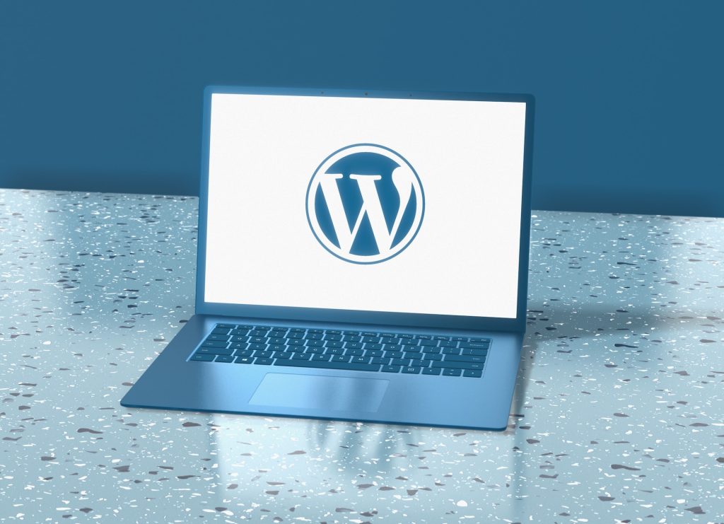 WordPress logo on a laptop. Changing your CMS aids website security.